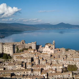 Aerial view of Bracciano city with the picturesque Bracciano Lake in the background, showcasing the charm of this Italian destination.