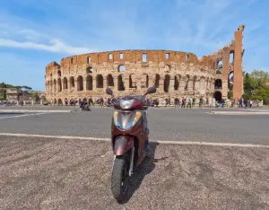 Scooter parked with a perfect view of the Colosseum in Rome highlighting the unique experience of our scooter guided tours