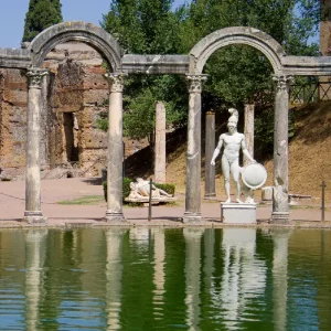 An ancient Roman inspired rectangular pool surrounded by classical statues at Villa Adriana also known as Hadrians Villa in Italy