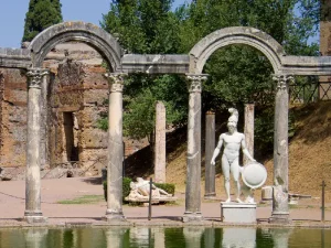 An ancient Roman inspired rectangular pool surrounded by classical statues at Villa Adriana also known as Hadrians Villa in Italy