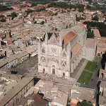 Aerial view of Duomo di Orvieto and surrounding buildings captured by a drone