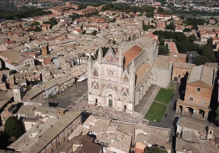 Aerial view of Duomo di Orvieto and surrounding buildings captured by a drone