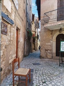 Typical street view of Sermoneta with old chair and stone buildings