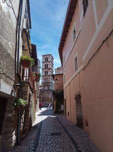 View of the bell tower of the church in Sermoneta from a typical alleyway
