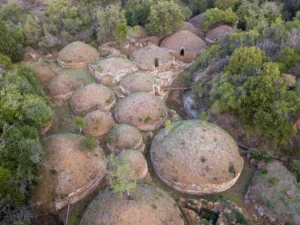 Aerial View of the Banditaccia Necropolis Cerveteri Scoot around Rome Drone view of the Necropolis of Banditaccia in Cerveteri displaying ancient Etruscan tombs and grassy