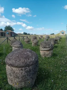Etruscan Urns at the Entrance of Monterozzi Necropolis Scoot around Rome Photo of ancient Etruscan funerary urns at the entrance of the Monterozzi Necropolis in Tarquinia