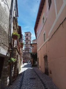 View of the bell tower of the church in Sermoneta from a typical alleyway