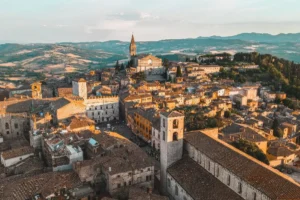 Aerial drone view of Todi village with Piazza del Popolo in the foreground