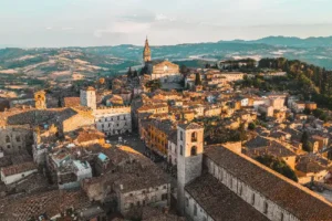 Aerial drone view of Todi village with Piazza del Popolo in the foreground