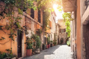 Peaceful cobblestone street in Rome with ivy covered buildings in the morning light